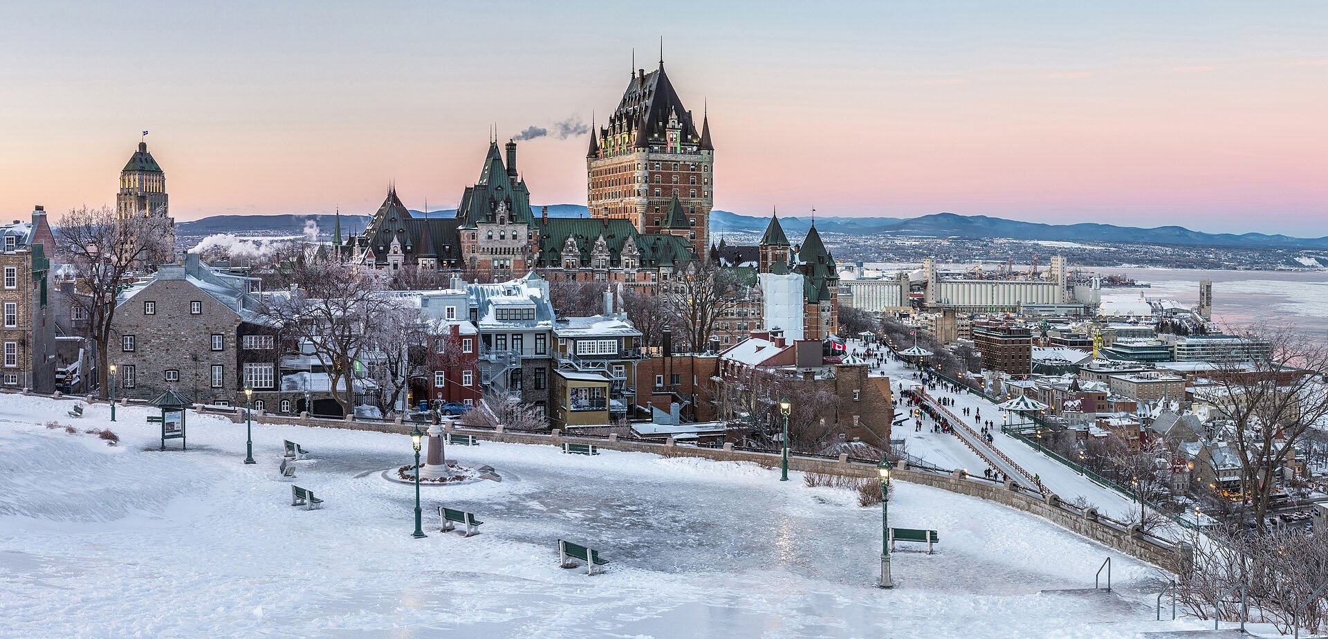 Old Quebec City under snow at dusk, with the Chateau Frontenac above the ice-filled St. Lawrence River